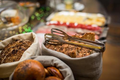 a plate of food with a fork and some bread at Hotel U Zlateho jelena in Prague