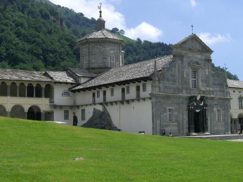 a large building with a grassy hill in front of it at Santuario di Oropa in Biella