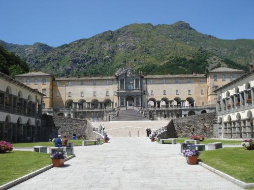 a large building with a mountain in the background at Santuario di Oropa in Biella
