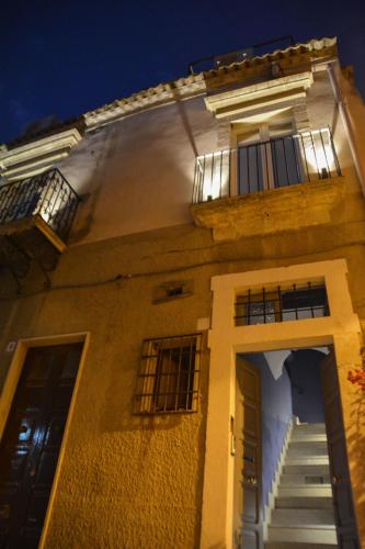 a large building with a staircase and a balcony at Ziolì in Noto