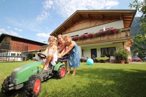 a group of people standing next to a tractor at Landhaus Zell in Längenfeld