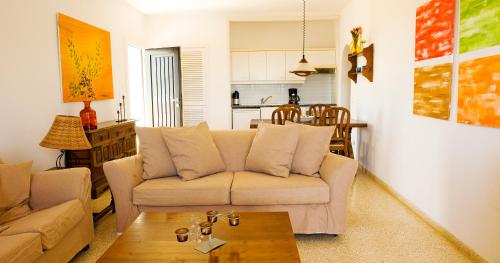a living room with a couch and a table at Apartamentos Parque Mar in Cala d´Or