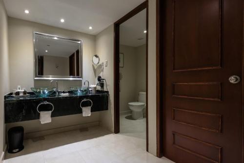 a bathroom with a sink and a toilet at Barceló Aruba - All Inclusive in Palm-Eagle Beach