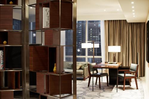 a living room with a table and a dining room at Park Hyatt New York in New York