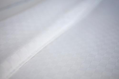 a close up of a bed with a white sheet at The Crossroads Hotel - Newburgh in Newburgh