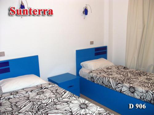 Un pat sau paturi într-o cameră la Sunterra Resort