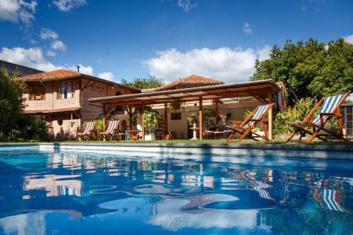 a swimming pool in front of a house at Rukka Lodge in Tumbaco