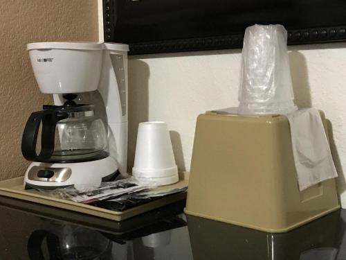 
a coffee maker sitting on top of a counter next to a blender at Townhouse Motel in Weed
