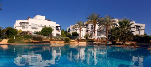 a large swimming pool in front of a building at Sunterra Resort in Sharm El Sheikh