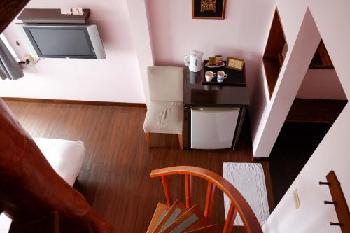 a living room with a tv and a chair at Bridge12th B&B in Yanliau