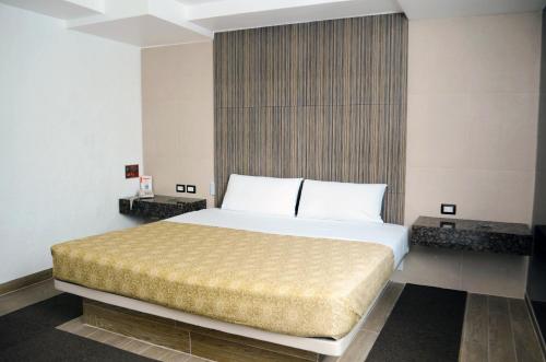 a bedroom with a large bed in a room at Hotel Santa Cruz in Mexico City
