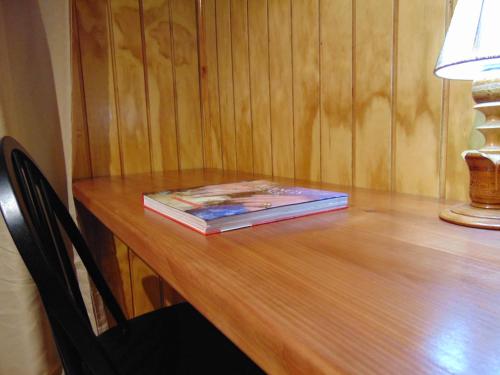 a book sitting on top of a wooden table at Cafe & Hostal Acurruka in Curacautín