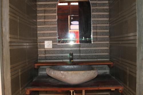 a bathroom with a sink and a mirror at The Tipsy Gypsy Hostel in Canggu