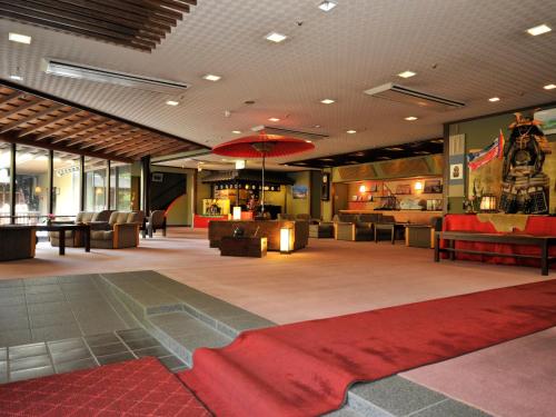 a lobby with a red rug on the floor at Nisshokan Bettei Koyotei in Nagasaki