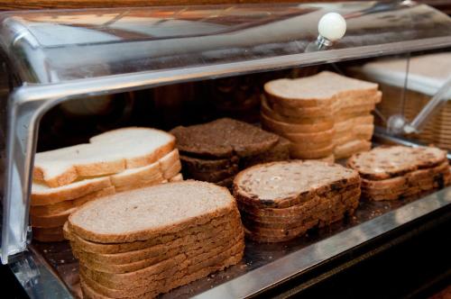 a group of breads and biscuits in a display case at Hotel Restaurant Vijlerhof in Vijlen
