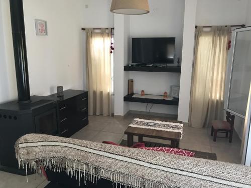 a living room with a couch and a flat screen tv at Casonas de Nono in Nono