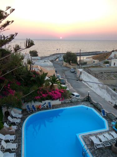 a swimming pool with a view of the ocean at Porto Castello in Fira