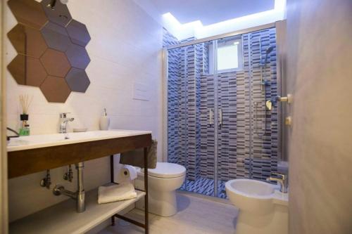 a bathroom with a sink and a toilet and a shower at BebNonnaMaria1928 in Salerno