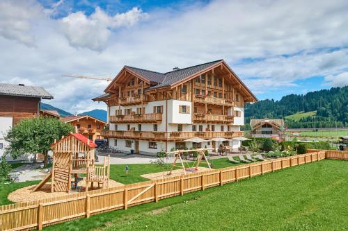a large building with a playground in a yard at Rainerhof in Flachau