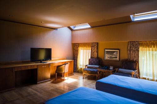 Ένα ή περισσότερα κρεβάτια σε δωμάτιο στο Ventura Boutique Hotel