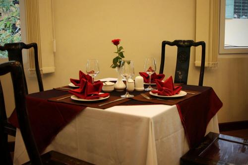 a table with red napkins and wine glasses on it at Sunny Hotel 1 in Hanoi