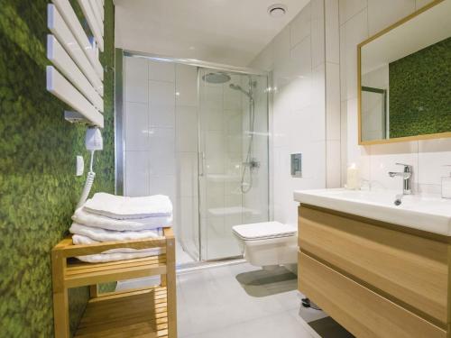 a bathroom with a shower and a sink and a toilet at VacationClub - Nadbrzeżna 12 Apartment in Mielno