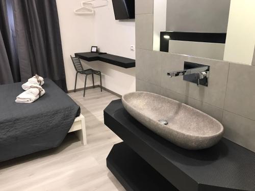 a bathroom with a sink and a bed at Sangiò Guest House in Rome