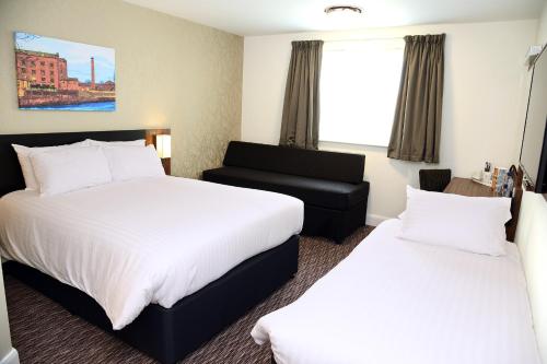 a hotel room with two beds and a couch at Blue Jay, Derby by Marston's Inns in Derby