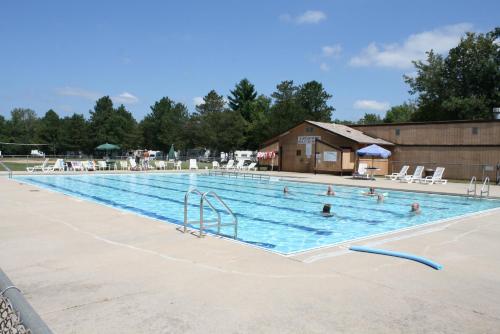 a large swimming pool with people in it at Pine Country Camping Resort in Belvidere