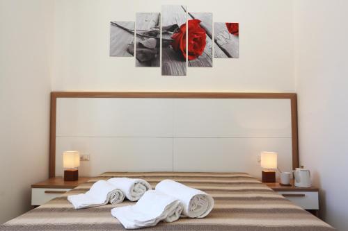 CerfignanoにあるIl Giardino Degli Aromiのタオルが敷かれたベッドのある寝室