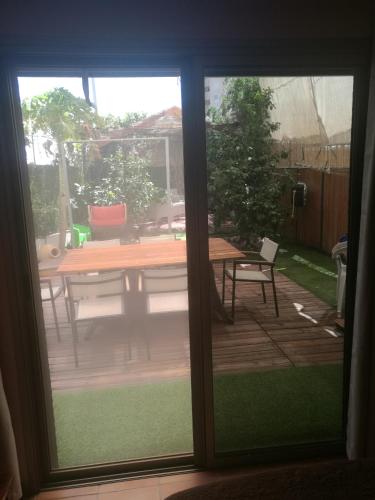 a sliding glass door of a patio with a table at Casa Rosa in Eilat