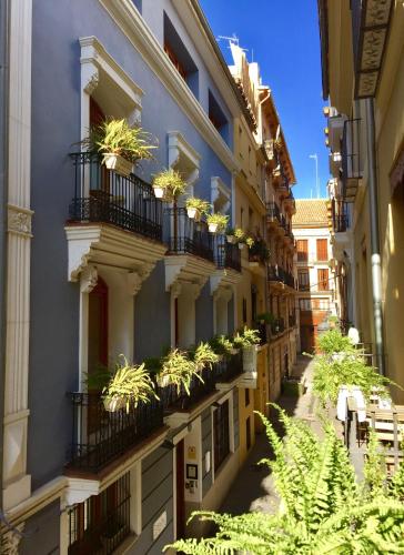 an apartment building with potted plants on the balconies at Edificio Palomar - PalomarGroup in Valencia