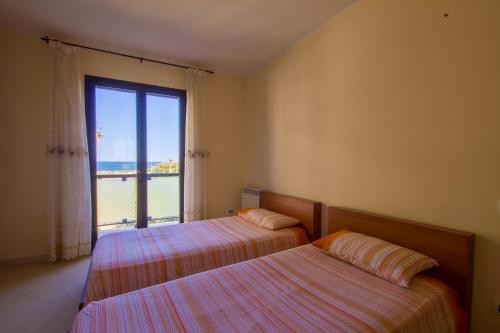 A bed or beds in a room at Residence Le Saline