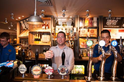 a man standing behind a bar in a pub at Canterbury Bell, Margate by Marston's Inns in Broadstairs