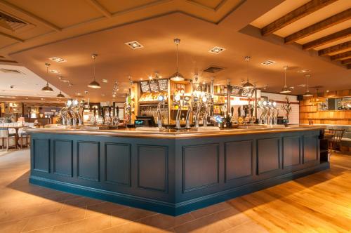 a bar in a restaurant with a blue counter at Canterbury Bell, Margate by Marston's Inns in Broadstairs