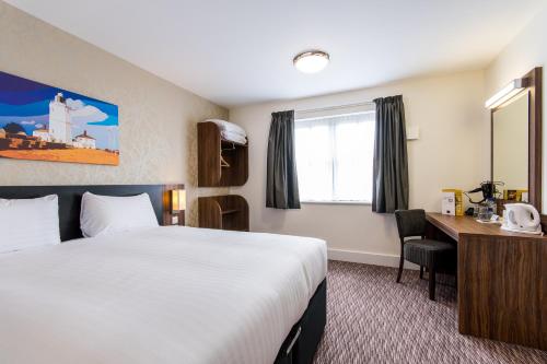 a hotel room with a bed and a desk at Canterbury Bell, Margate by Marston's Inns in Broadstairs