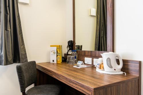 a desk in a room with a coffee maker on it at Canterbury Bell, Margate by Marston's Inns in Broadstairs