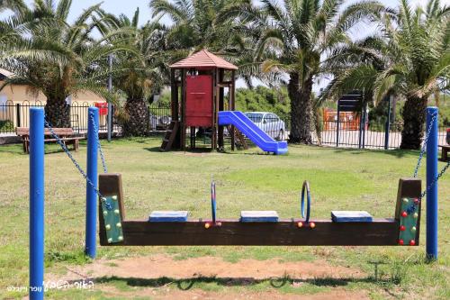 a park with a playground with a slide at Dor village in Dor