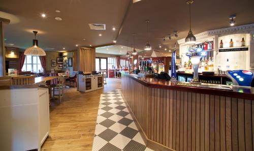 a bar in a restaurant with a checkered floor at Chain Runner, Livingston by Marston's Inns in Livingston
