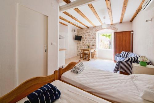 a bedroom with two beds and a living room at Apartments Aerial in Dubrovnik