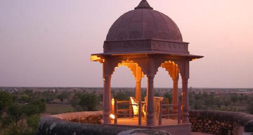 a gazebo with a table and chairs on top at Welcomhotel by ITC Hotels, Fort & Dunes, Khimsar in Khimsar
