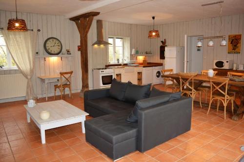 a living room with a couch and a table at Gite De Saba in La Celle-Condé