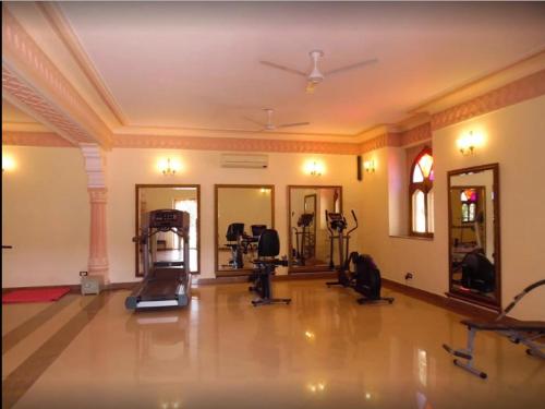 a gym with exercise equipment in a large room at Welcomhotel by ITC Hotels, Fort & Dunes, Khimsar in Khimsar