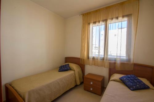 Ένα ή περισσότερα κρεβάτια σε δωμάτιο στο Residence Le Saline