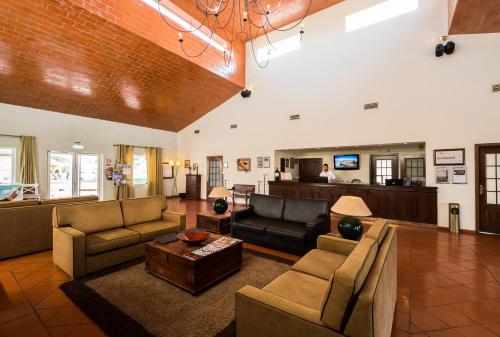 a large living room with couches and a table at Vila Gale Alentejo Vineyard - Clube de Campo in Albernoa