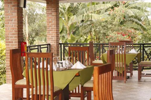 a table with a green table cloth on a patio at Airport Planet Lodge in Kingori
