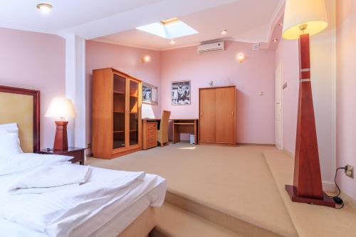 a bedroom with a bed and a desk in it at Ricardpol Noclegi in Tarnów