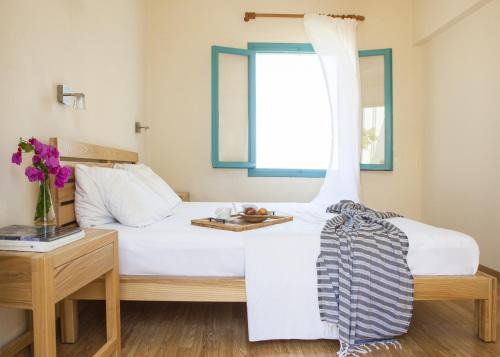 a bedroom with a bed with a tray of food on it at Villa Iokasti in Hersonissos