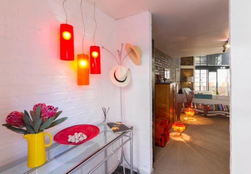 a living room with a red bowl on a counter at Waterkant Loft in Cape Town