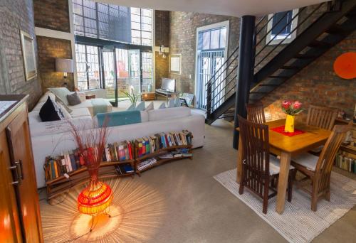 a large living room with a couch and a table at Waterkant Loft in Cape Town